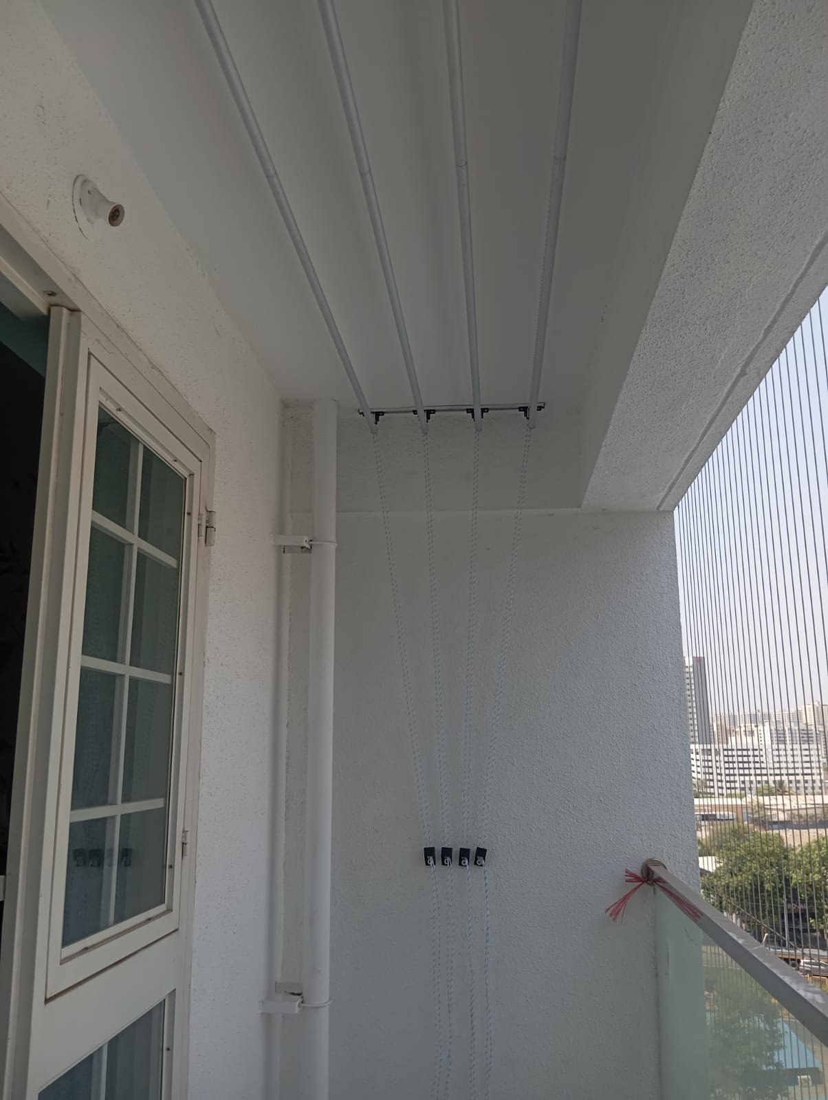 Ceiling mounted aluminium cloth drying hanger installed in an apartment balcony